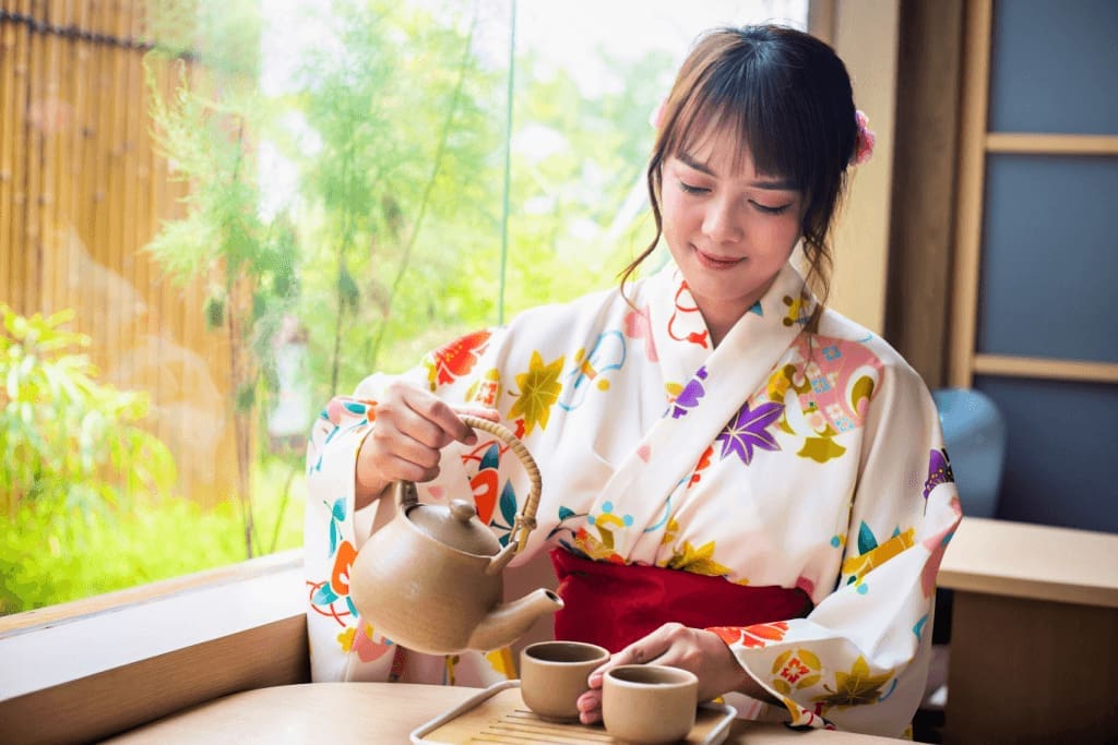 Traditional Japanese tea ceremony with a woman in a kimono.